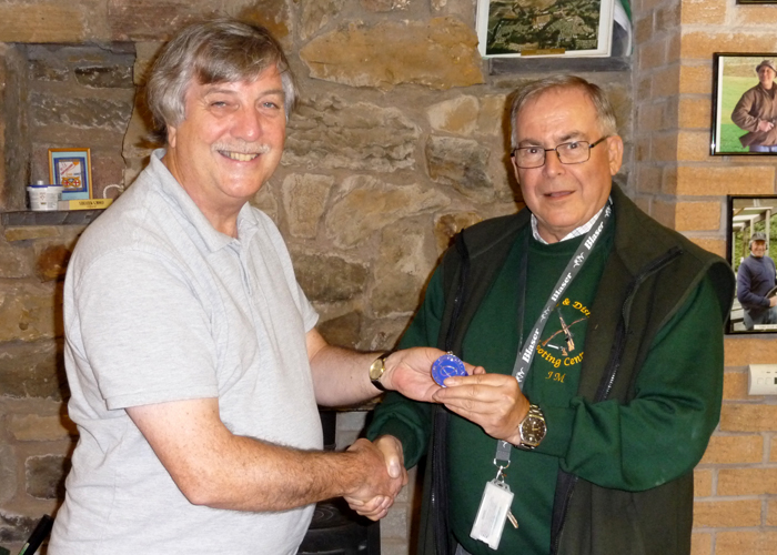 Photograph shows Osborn Spence - SSRA Airgun Secretary (left) presenting the SSRA Individual Air Pistol 'B' League - Summer 2019 - 2nd Place Medal to John Machin of Leek (right).