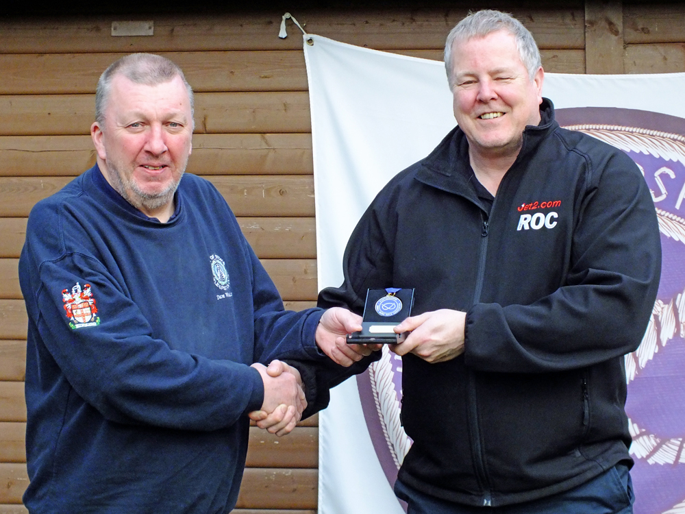 Photograph shows Dom Paskin of City of Stoke Rifle and Pistol Club (pictured right) receiving his SSRA Individual Air Pistol League - Winter 2025/2026 - 1st Place Medal from Dave Walker of City of Stoke RPC (pictured left).