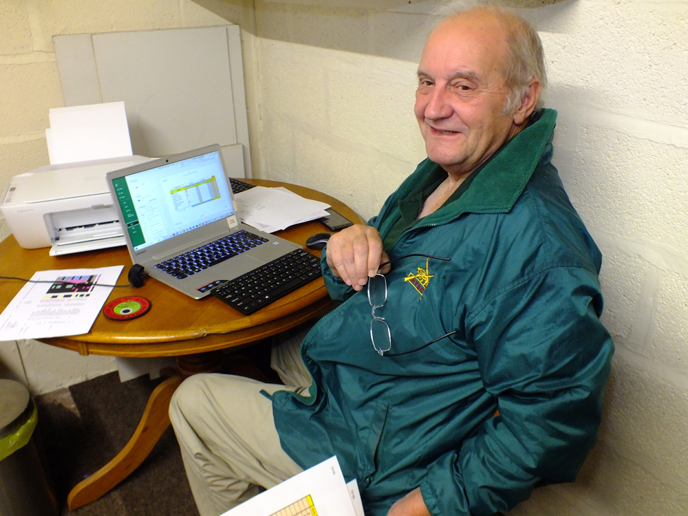 Photograph shows Bob Heath - SSRA Official Results Compiler - busily inputting scores as they are on passed to him from the scorers.