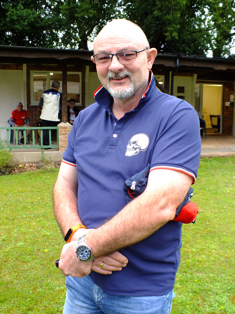Photograph shows Mark Evans waiting to get cracking with his target retrieving duties once the competitors have peppered the paper, shot by shot.
