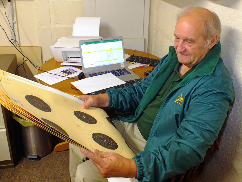 Photograph shows Bob Heath diligently verifying the targets and entering the scores on the computer. Keep it up Bob ... you're doing a grand job lad!