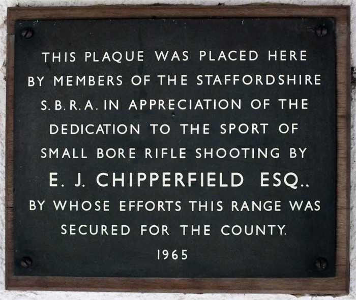 Photograph shows the memorial plaque mounted on the clubhouse wall, dedicated to E.J. Chipperfield, to commemorate his efforts in securing the range for the county.