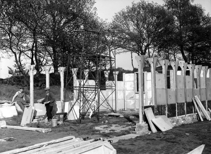Photograph shows the new clubhouse being erected. The various sections of the clubhouse were all numbered, so that they could be assembled correctly.
