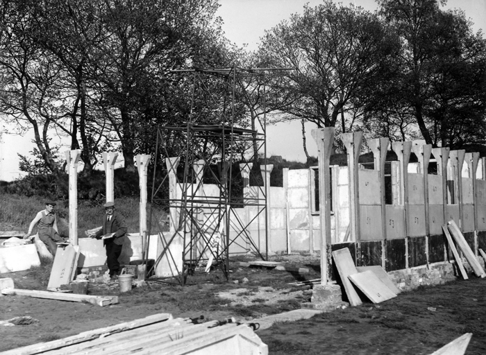 Photograph shows the new clubhouse being erected. The various sections of the clubhouse were all numbered, so that they could be assembled correctly.