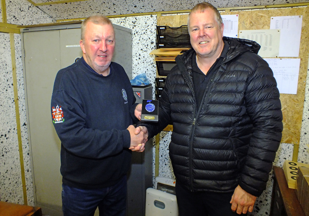 Photograph shows Dom Paskin of City of Stoke Rifle and Pistol Club (pictured right) receiving his SSRA Individual 10 Metres Air Pistol - 'A' League - Summer 2026 - 2nd Place Medal from Dave Walker of City of Stoke Rifle and Pistol Club (pictured left).
