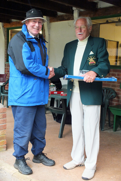 Photograph shows N. Peters (pictured left) receiving the Class 'A' First Place Prize from SSRA President, Major (Retired) Peter Martin, MBE (pictured right).