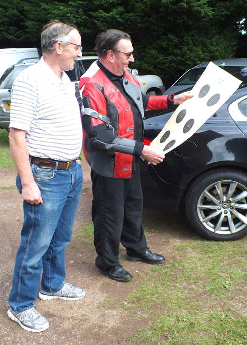 Photograph shows two competitors checking targets, and possibly thinking 'How hard can it be?'