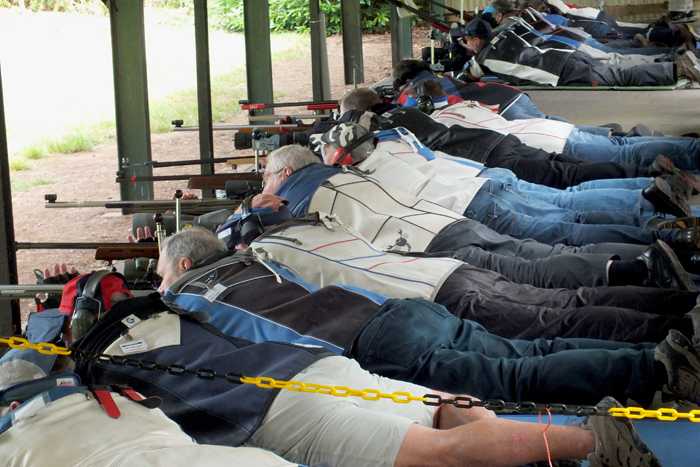 Photograph shows competitors on the firing line, doing what they do best.