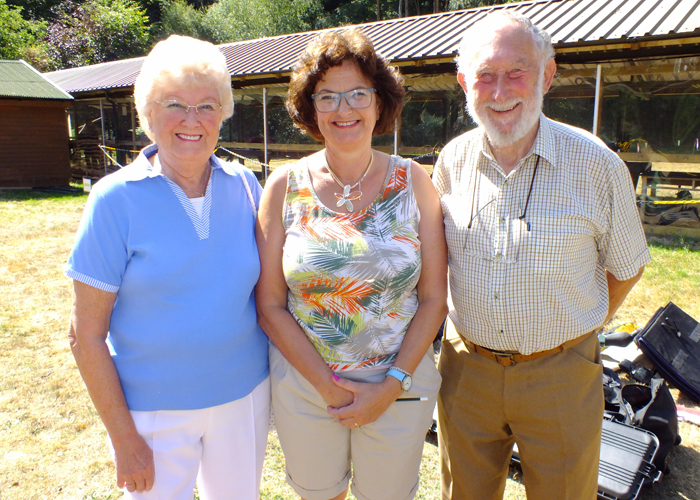 Photograph shows Judith Simcock, (pictured centre) enjoying a break from scoring duties, relaxing with her parents in the sunshine.