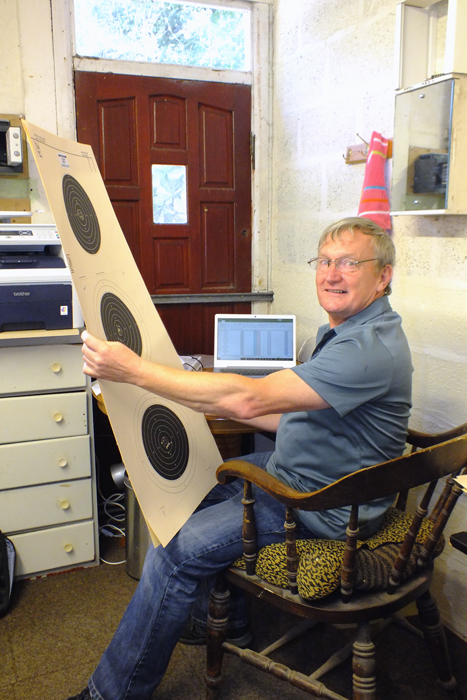 Photograph shows the Clerk to the Scorers, working tirelessly checking targets and compiling the scores.