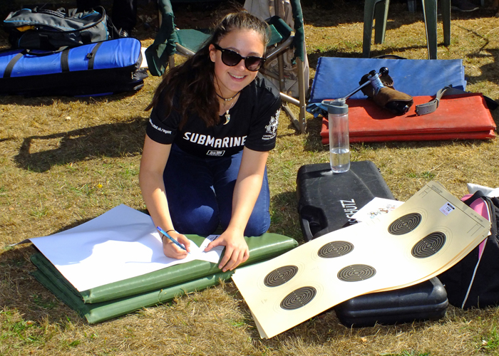 The above photograph shows one of the younger entrants of the competition carefully preparing her targets - and enjoying the sunshine too.