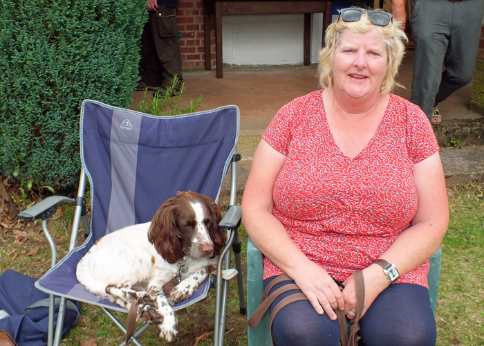 Photograph shows the perfect way to relax - as the wife of one of the competitors, and their trusty trainee gun dog, sit restfully, soaking up the sunshine.