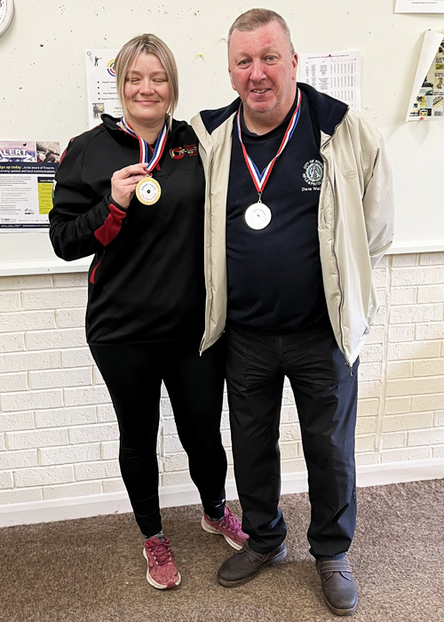 Photograph shows Steph Reynolds, pictured left, and David Walker, pictured right, wearing their respective medals with pride.
